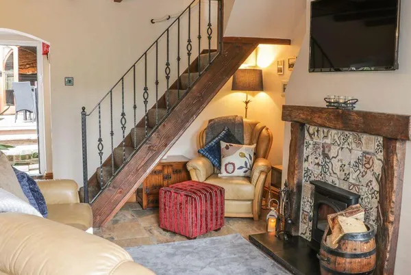 31 Riverside living room with fireplace and iron staircase