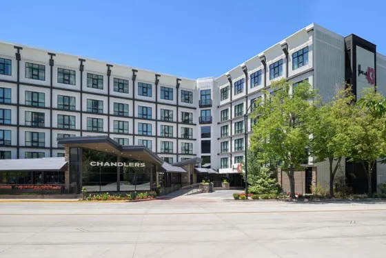 Large white building with a store in front of it