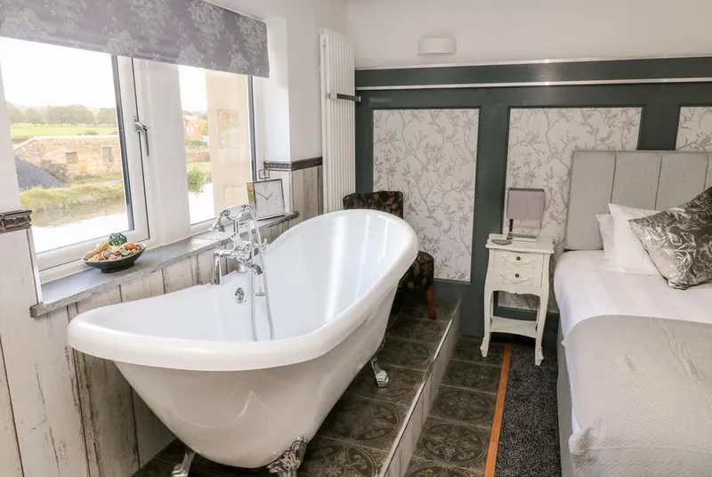 Lock View Nordic Spa bedroom with freestanding bath and canal views