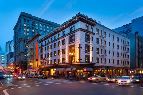Building on a city street with cars on the street
