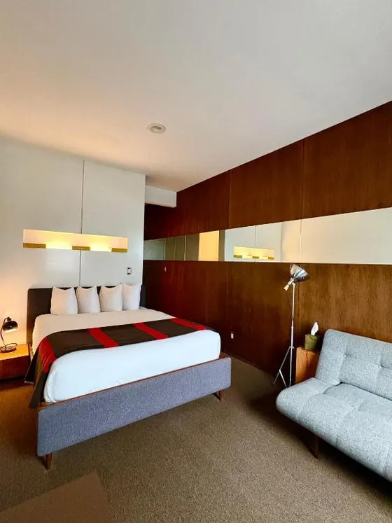 Bedroom with a large bed and a chair