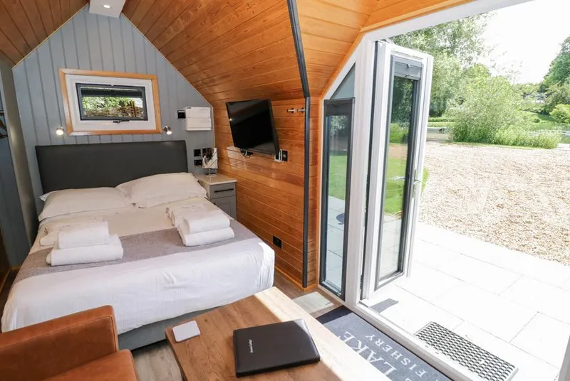 Acorn Lodge At Bridge Lake Farm & Fishery studio interior with bed and open doors