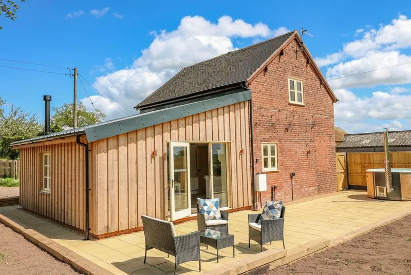 Acorn Lodge brick-and-timber lodge with patio seating