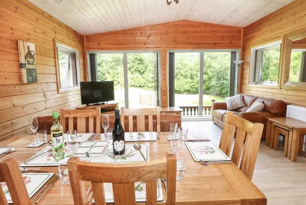Kipling Lodge open-plan dining area set for dinner with wine