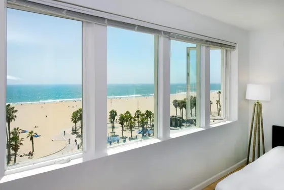 Bedroom with windows with a view of the beach