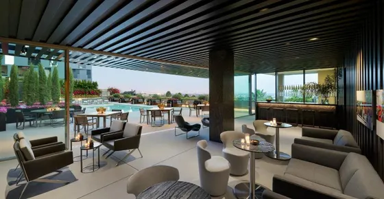 Hotel lobby with tables and chairs and a pool