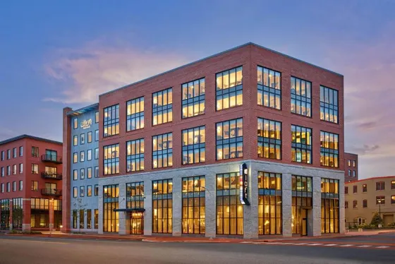 Large brick building with many windows at dusk