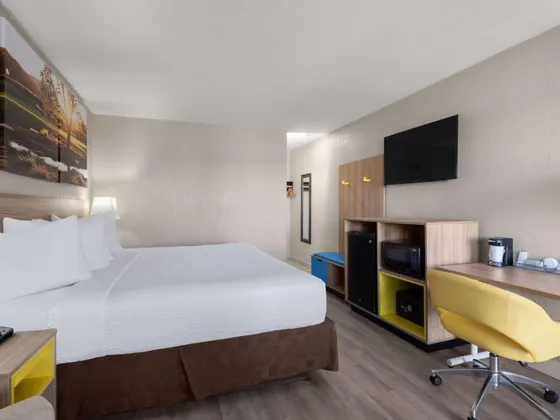 Hotel room with a large bed and a desk