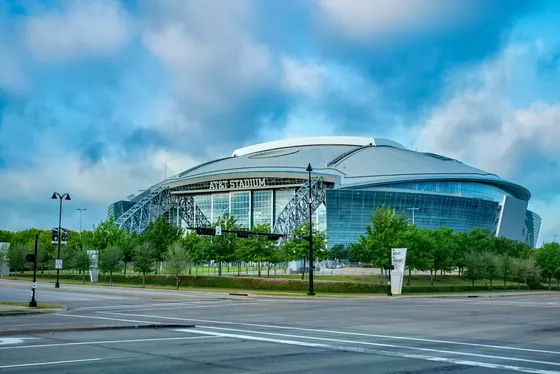 AT&T Stadium glass front under a cloudy sky