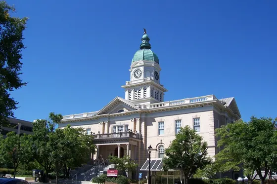 Athens City Hall and its clock tower beneath a clear blue sky