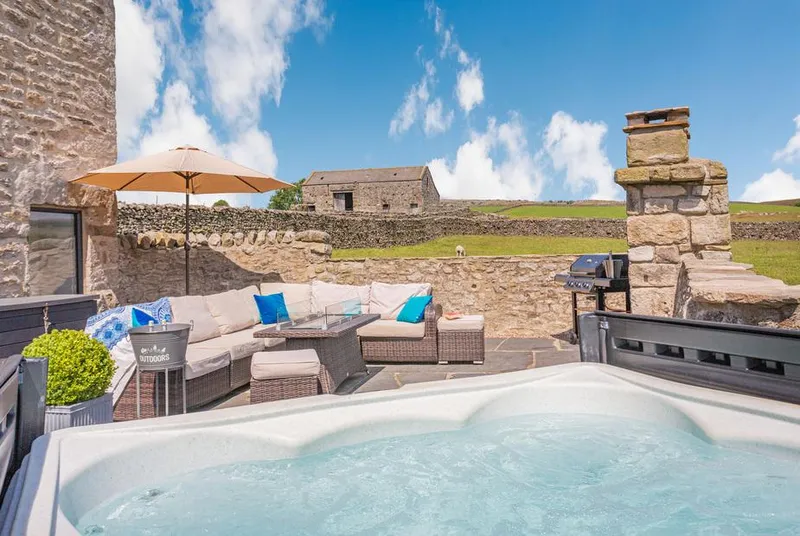Dallicar House outdoor hot tub with Dales stone wall backdrop