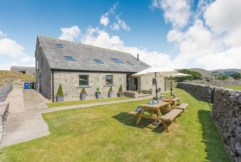 Dallicar House stone barn with lawn and Dales hillside