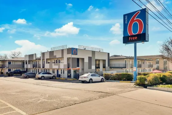 Two-story motel with a tall blue Motel 6 sign