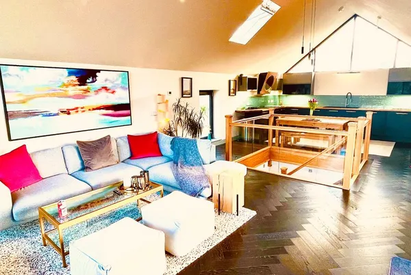 Avalennek open-plan living area with kitchen and sofas