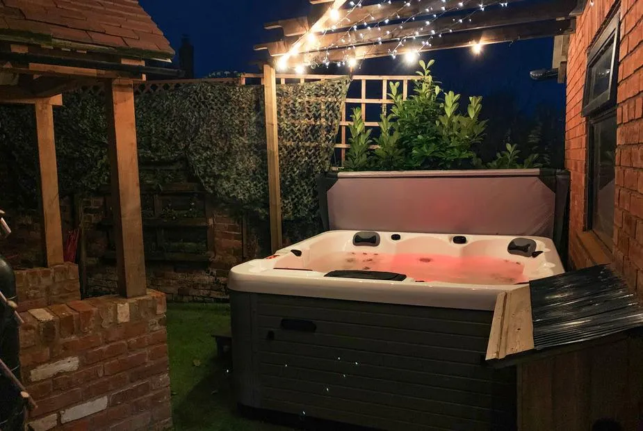 Bank House Barn night hot tub with festoon lighting