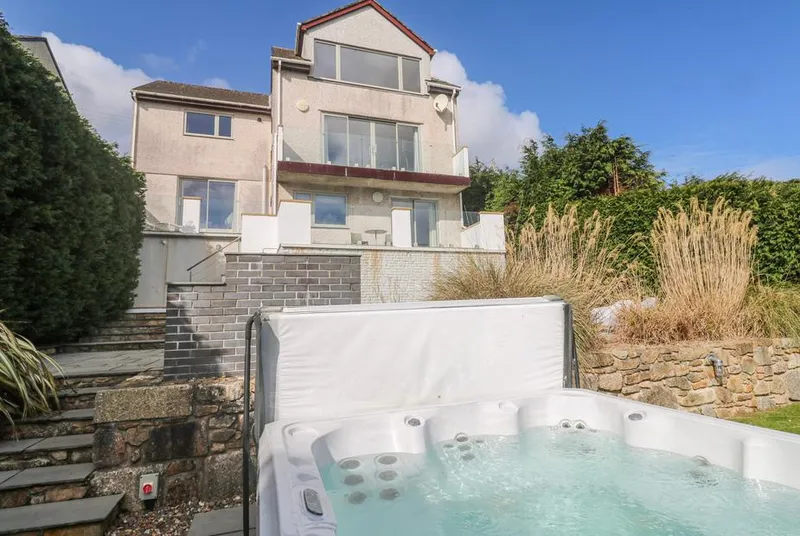 Bayside hot tub below the house facade