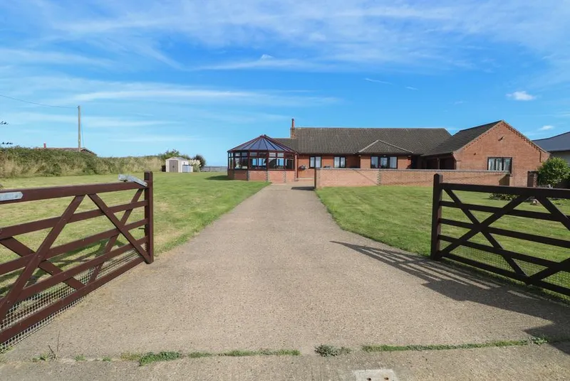 Beach Haven bungalow from entrance gates with coastal setting