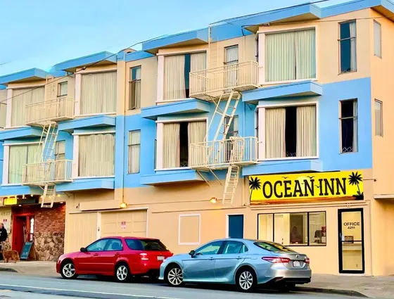 Two cars parked in front of a building