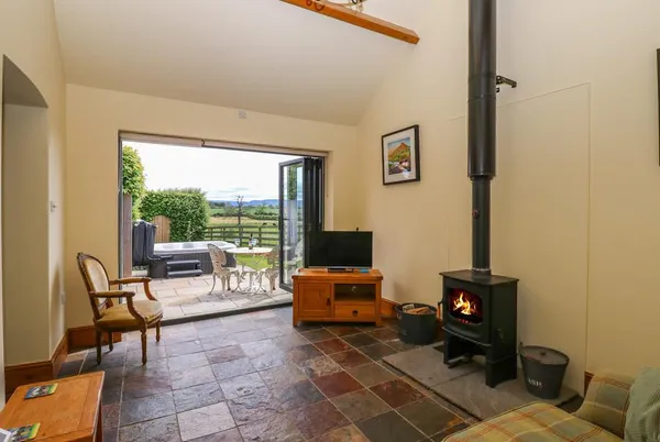 Lovesome Cottage vaulted living room with wood burner and bifold doors