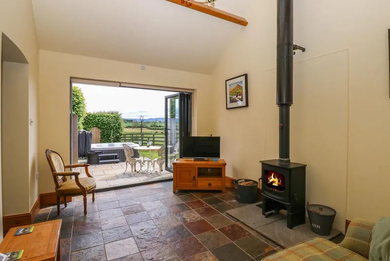 Lovesome Cottage vaulted living room with wood burner and bifold doors