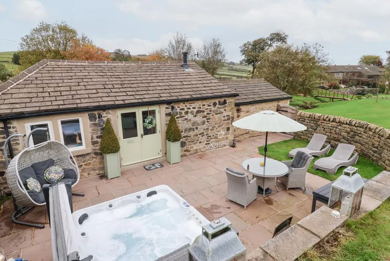 Beckside Cottage hot tub on stone patio with Yorkshire hills