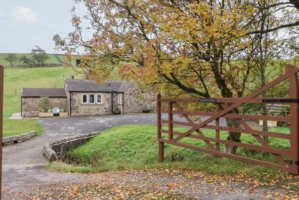 Beckside Cottage stone front with gate and autumn tree