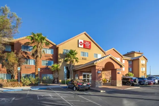 Hotel with a car parked in a parking lot