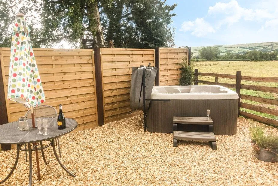 Bicton Lodge hot tub on the gravel terrace