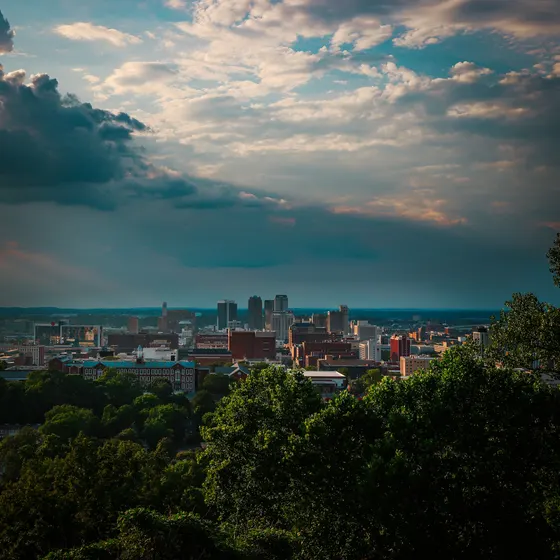 Downtown Birmingham skyline beneath dramatic clouds