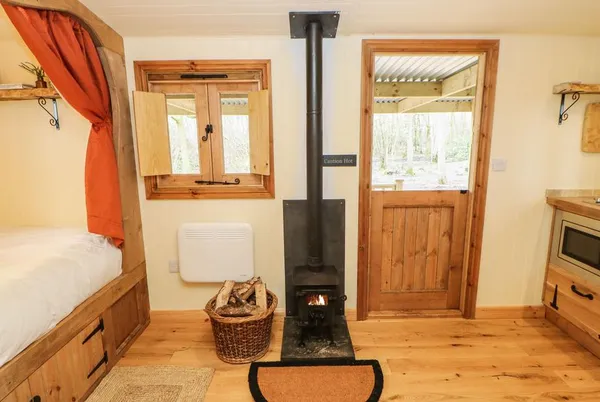 Bracken Fern interior with bed nook, wood burner and porch door