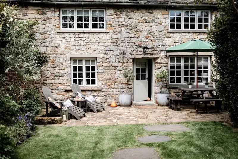 Bridge End Cottage stone facade with flagstone patio