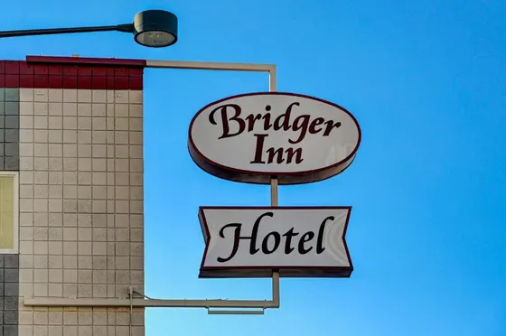 Two signs that say burger inn and a hotel
