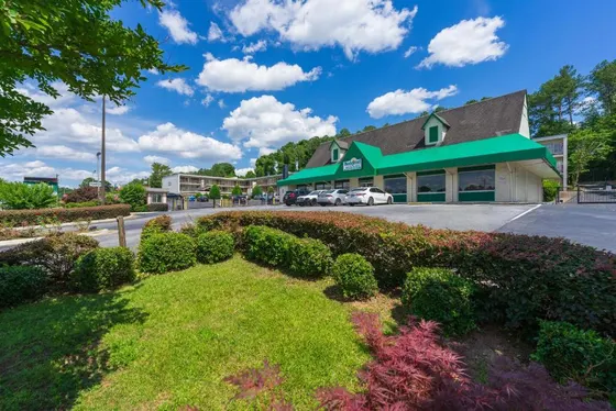 Building with a green roof and a parking lot