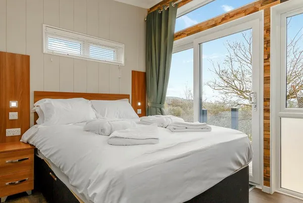 Burrington Premier bedroom with floor-to-ceiling windows and countryside views
