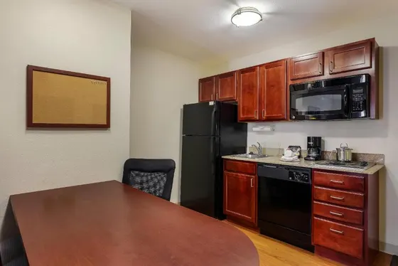 Kitchen with a black refrigerator and a table