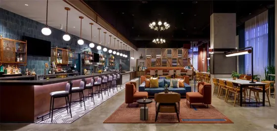 Bar with a blue couch and some chairs