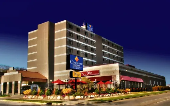 Tan hotel with a patio of red umbrellas