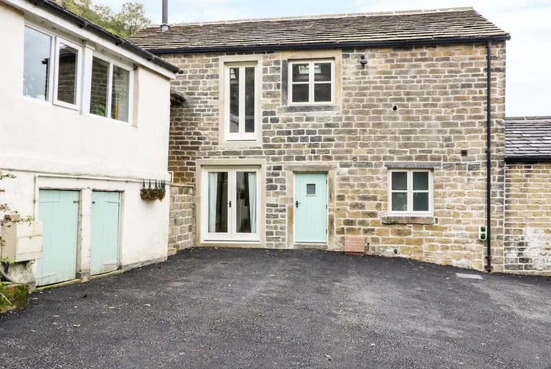 Morgan's Barn stone facade with mint-green doors
