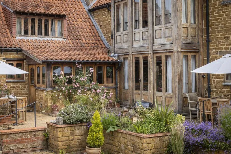 Chestnut, Swerford stone courtyard facade with timber-framed windows