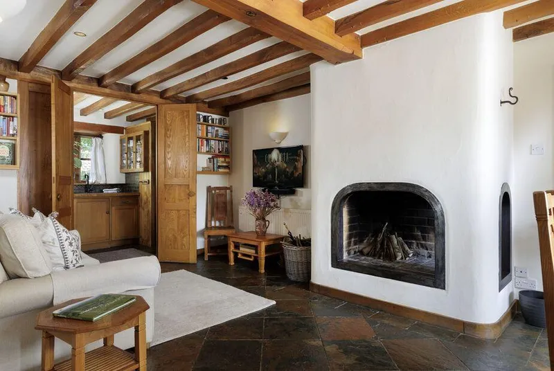 Chestnut, Swerford beamed lounge with sculptural white fireplace
