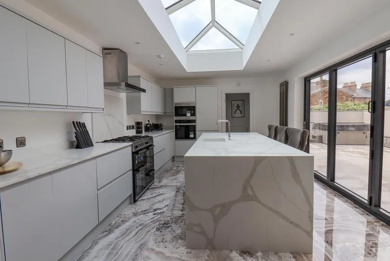 Church View kitchen with marble waterfall island and onyx floor tiles