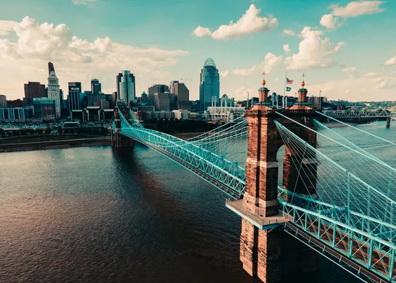 Blue Roebling Bridge crossing toward downtown towers