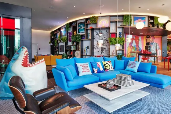 Living room with a blue couch and a table