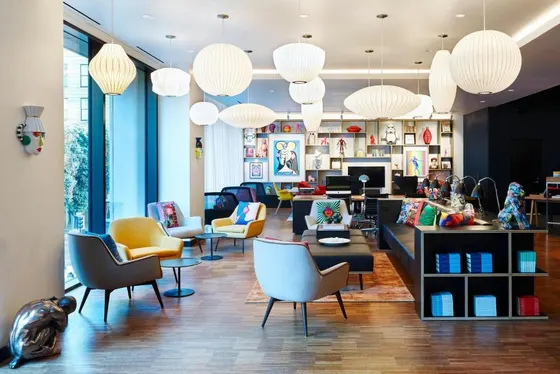 Lobby with chairs and tables and chandeliers