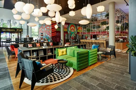 Restaurant with green chairs and a bar