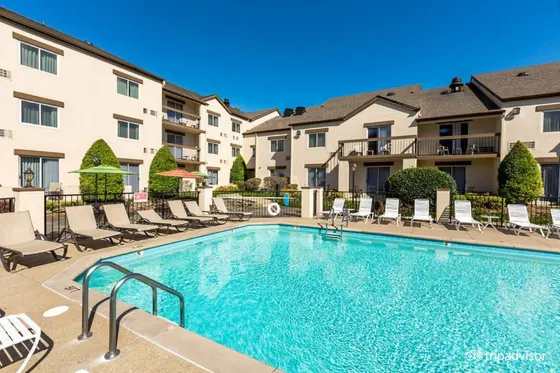 Swimming pool in a courtyard with chairs and condos