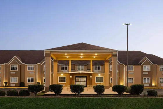 Large apartment building with a large front yard