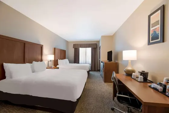 Hotel room with two beds and a desk
