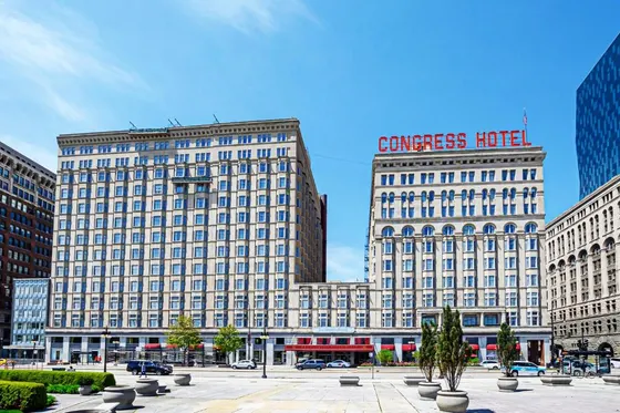 Large building in a city with two tall buildings