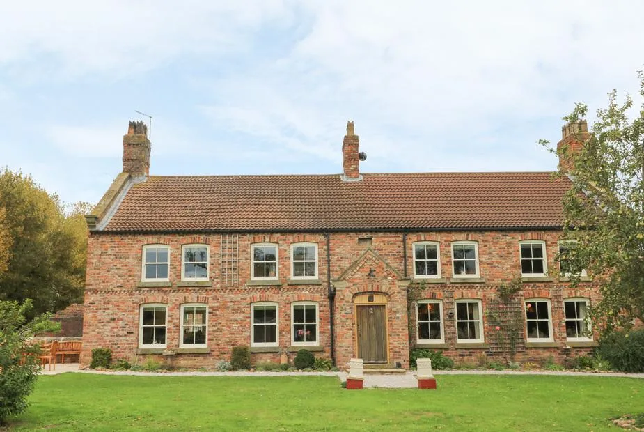 Copmanthorpe Hall red brick farmhouse facade with lawn
